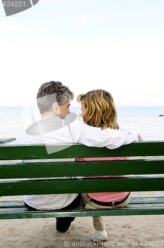 Image of Mature romantic couple on a bench