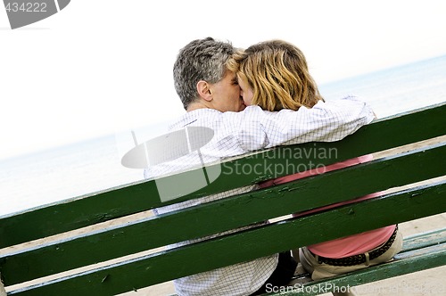 Image of Mature romantic couple on a bench