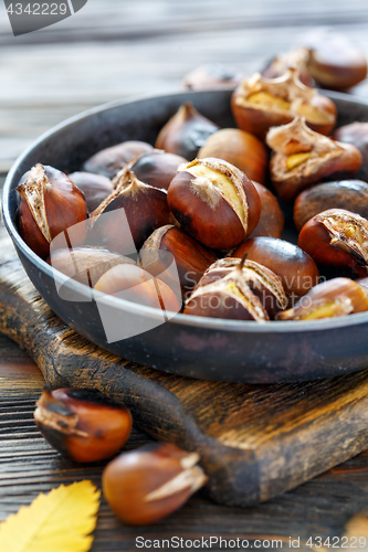 Image of Roast chestnuts in a pan closeup.