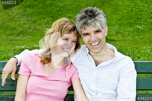 Image of Mature romantic couple on a bench