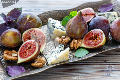 Image of Blue cheese and ripe figs on a bronze tray.