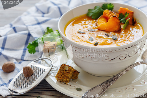 Image of Pumpkin soup with chunks of baked pumpkin and spices.