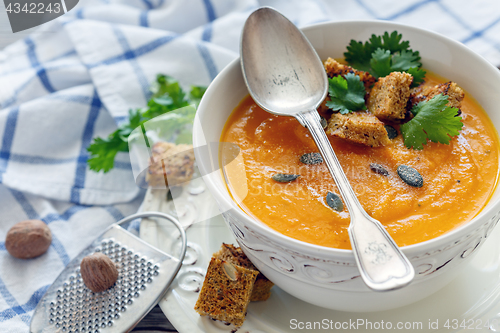 Image of Spicy pumpkin soup in a porcelain bowl.