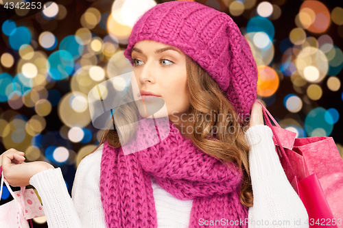 Image of woman in winter hat with christmas shopping bags