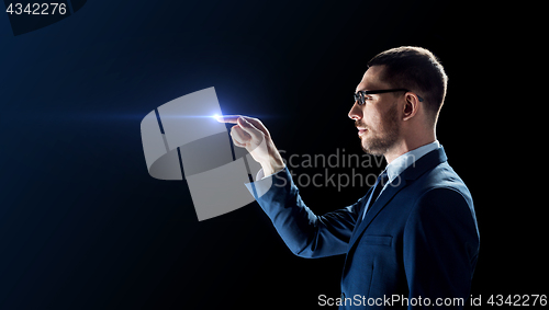 Image of businessman in glasses with laser light over black