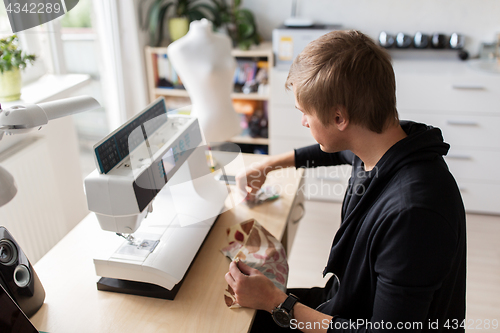 Image of fashion designer with making dress at studio