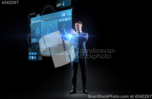 Image of businessman in suit with virtual projection