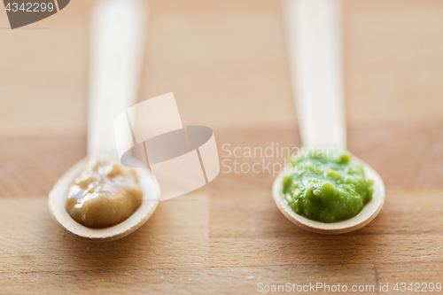 Image of vegetable or fruit puree or baby food in spoons