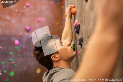 Image of young man exercising at indoor climbing gym