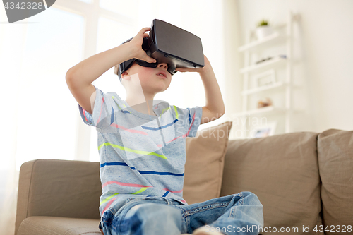 Image of little boy in vr headset or 3d glasses at home