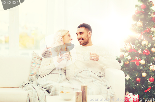 Image of happy couple at home with christmas tree