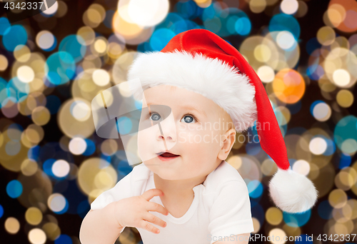 Image of little baby boy in santa hat at christmas