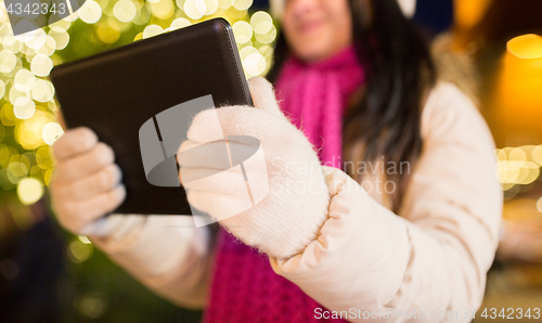 Image of close up of woman with tablet pc at christmas