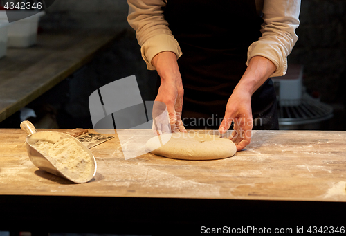 Image of chef or baker cooking dough at bakery