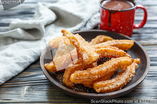 Image of Dish with churros and hot chocolate.