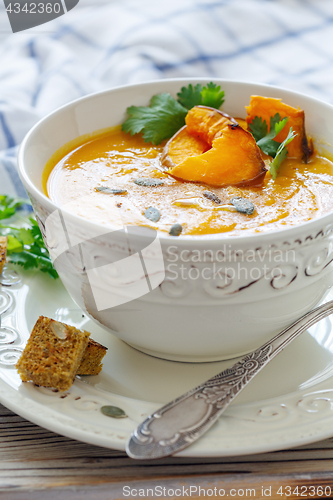 Image of Pumpkin soup with chunks of baked pumpkin and spices.