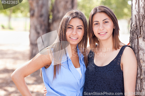 Image of Two Beautiful Ethnic Twin Sisters Portrait Outdoors.