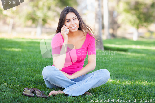 Image of Beautiful Young Ethnic Woman Talking on Her Smartphone Outside.
