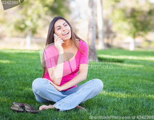 Image of Beautiful Young Ethnic Woman Talking on Her Smartphone Outside.