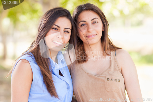 Image of Two Beautiful Ethnic Twin Sisters Portrait Outdoors.