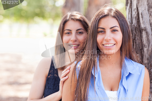 Image of Two Beautiful Ethnic Twin Sisters Portrait Outdoors.