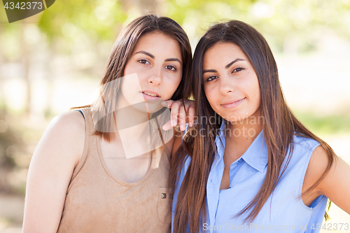 Image of Two Beautiful Ethnic Twin Sisters Portrait Outdoors.