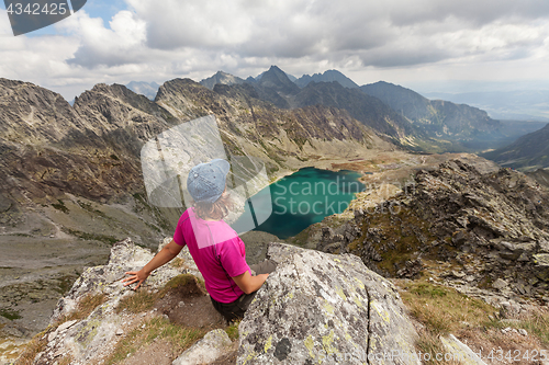 Image of Hiking woman admiring the beauty of rocky Tatra mountains