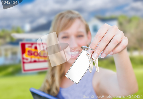 Image of Woman Holding New House Keys with Blank Card In Front of Sold Re