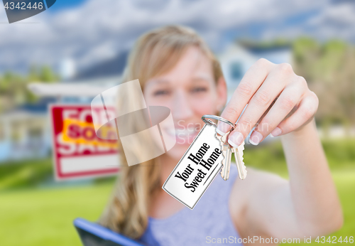 Image of Woman Holding New House Keys with Your Home Sweet Home Card In F