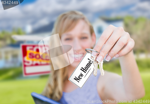 Image of Woman Holding New House Keys with New Home Card In Front of Sold