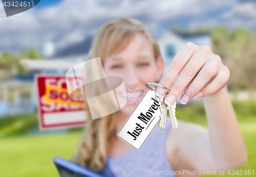 Image of Woman Holding New House Keys with Just Moved Card In Front of So