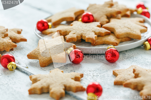 Image of Ginger cookies and red Christmas balls.