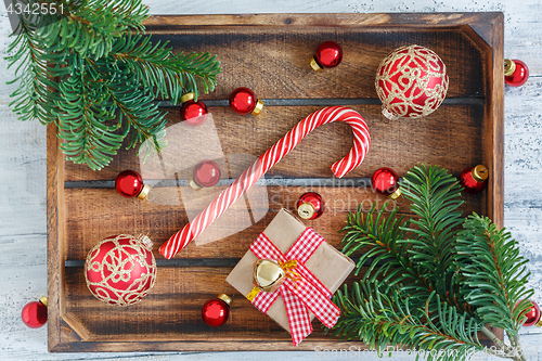 Image of Christmas balls, candy and fir-tree branches.
