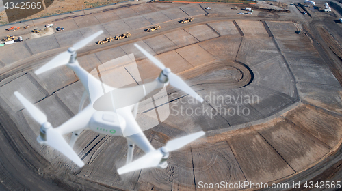 Image of Unmanned Aircraft System (UAV) Quadcopter Drone In The Air Over 