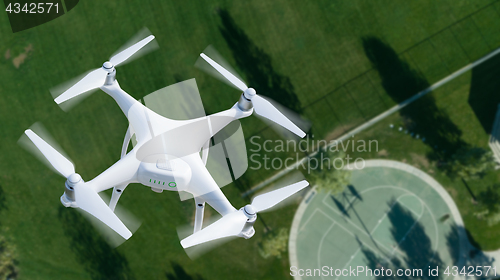 Image of Unmanned Aircraft System (UAV) Quadcopter Drone In The Air Over 