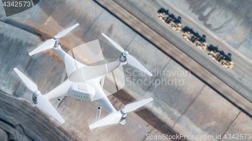 Image of Unmanned Aircraft System (UAV) Quadcopter Drone In The Air Over 