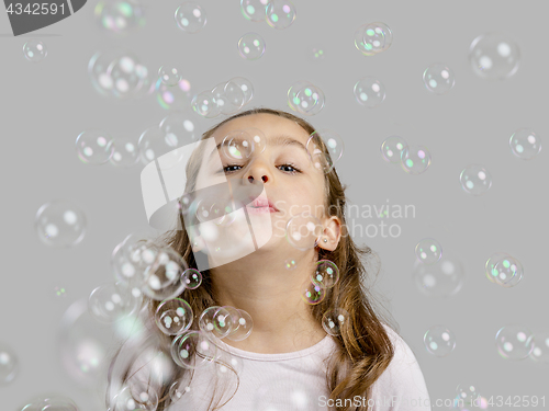 Image of Girl playing with soap bubbles