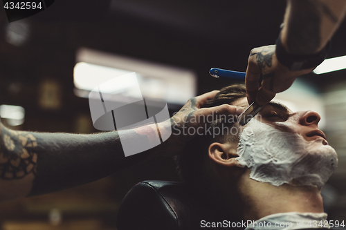 Image of Barber shaving client