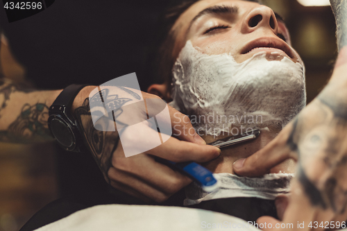 Image of Barber shaving client