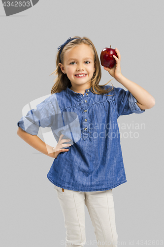 Image of Cute girl holding an apple