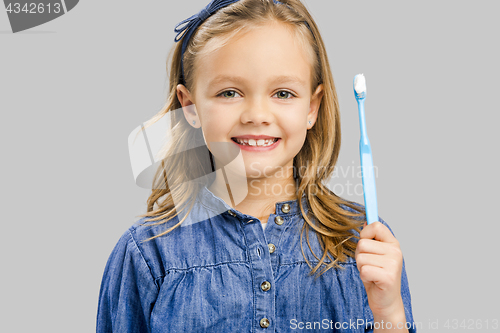 Image of Little girl brushing teeth