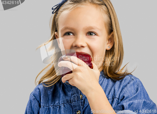 Image of Cute girl holding an apple