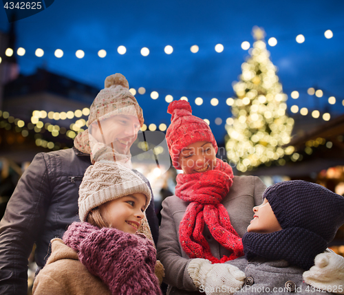 Image of happy family outdoors at christmas eve