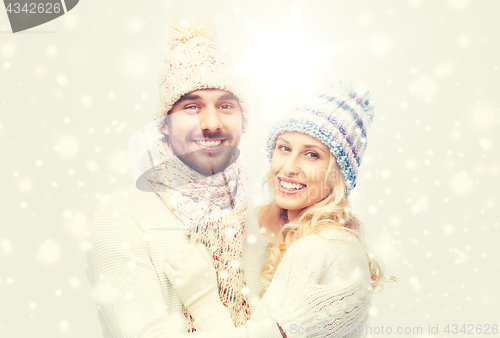 Image of smiling couple in winter clothes hugging