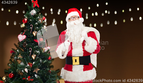 Image of santa claus with bag and christmas tree