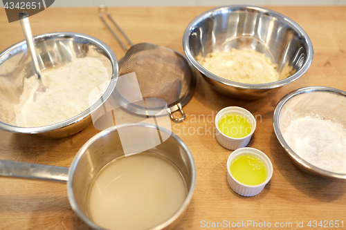 Image of bowls with flour and egg whites at bakery kitchen