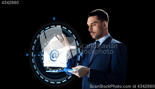 Image of businessman with tablet pc and e-mail hologram