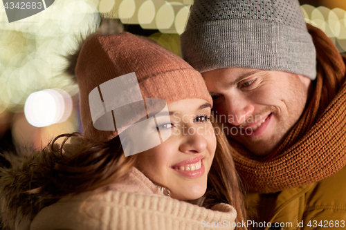 Image of close up of happy couple in winter clothes