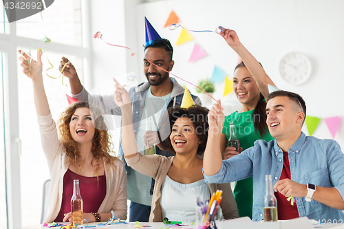 Image of happy team with confetti at office birthday party
