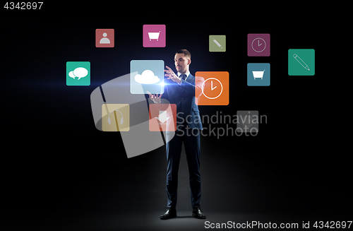 Image of businessman with menu icons on virtual screen